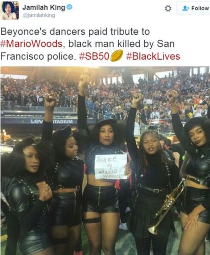 Beyoncé’s backing performers furtively hold up the sign that had CBS directors sphincter muscles working overtime - #CutToTheWideShot