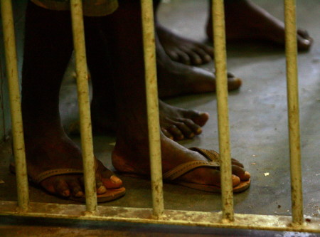 - PHOTO TAKEN 28OCT05 - Prisoners stand in a cell at the Port Moresby police station October 28, 200..