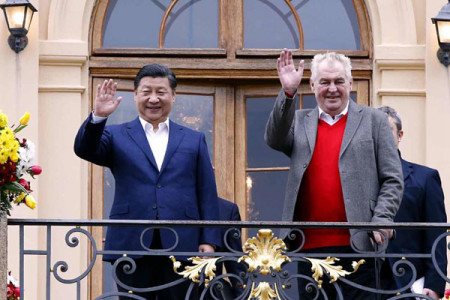 Visiting Chinese President Xi Jinping, left, and Czech President Milos Zeman wave to the press before holding an informal meeting at the Lany chateau, the host's private residence