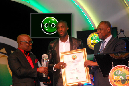 (Right to left) CAF President, Alhaji Issa Hayatou assisted by the former Delta State Governor, Dr. Emmanuel Uduaghan, decorating Yaya Toure as the 2014 African Footballer of the Year Award at the award ceremony held at Eko Hotel, Lagos.