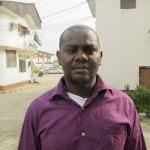 Okene poses for photograph after an interview with Reuters outside an hotel in Nigeria's oil city of Warri