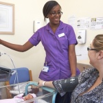 midwife with patient and baby on ward