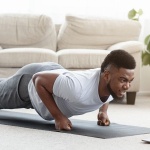 sporty-black-man-making-fist-plank-exercise-in-royalty-free-image-1592516283