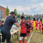 Mr-Adesanlu-NCL-Chair-handing-out-medals-to-the-Junior-LACON-runners-up