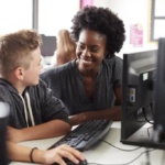 teacher-helping-male-high-school-student-working-a-2021-08-26-16-15-13-utc-min-1024×683